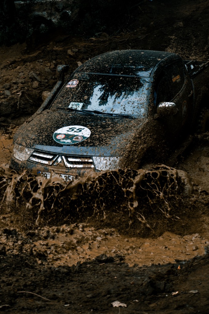Mitsubishi offroader ploughing through deep mud